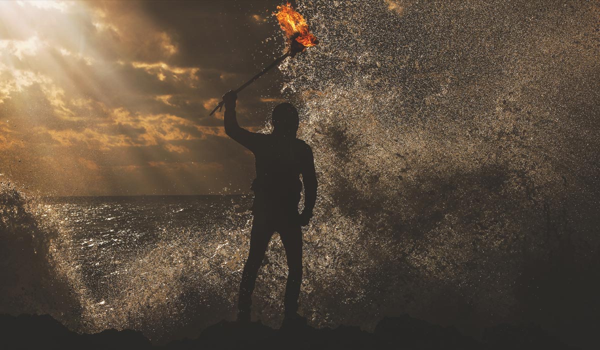 Man with torch in ocean