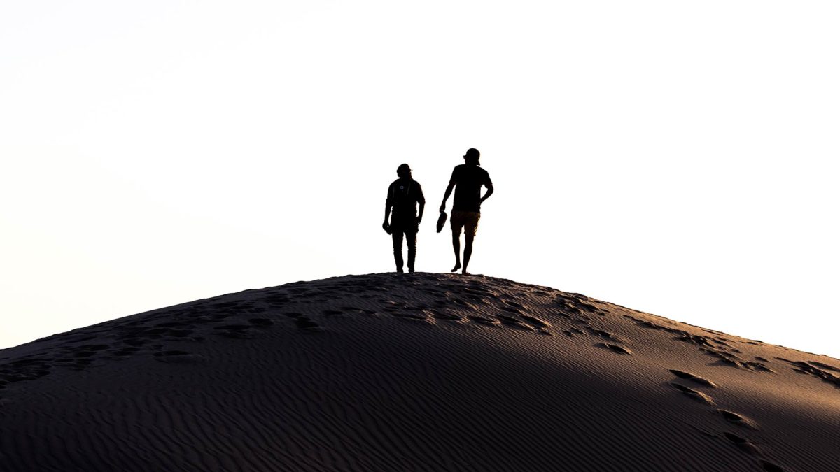 people walking in desert story sage