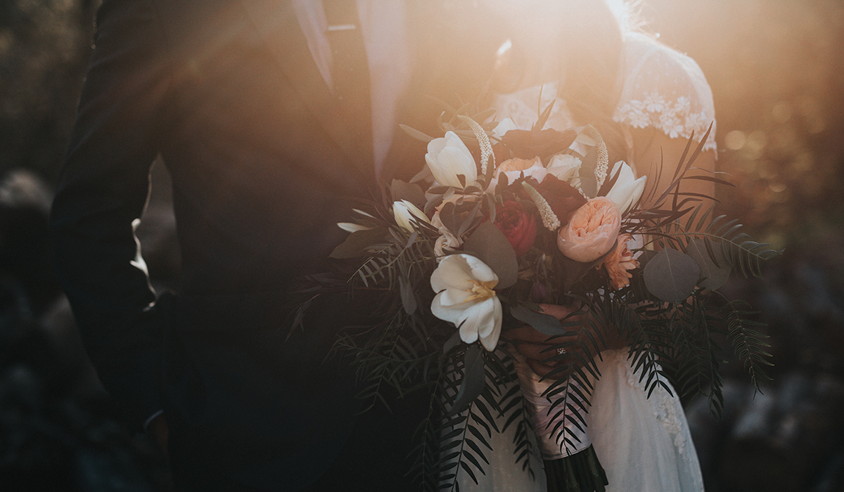 a bride and groom without their faces showing posing for a photo