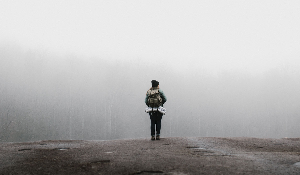 a woman hiking in the fog
