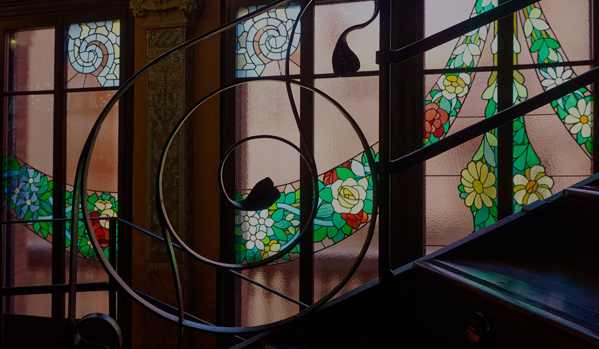wire art in front of a stained glass window