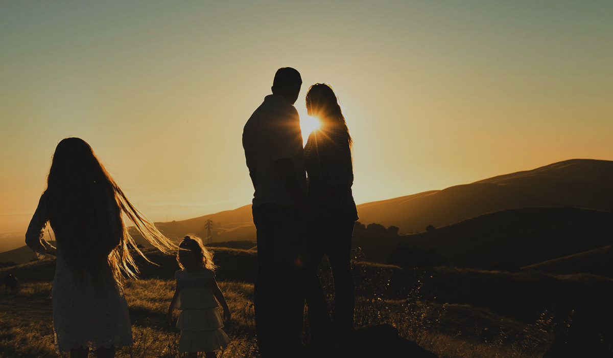 a family outdoors during sunset