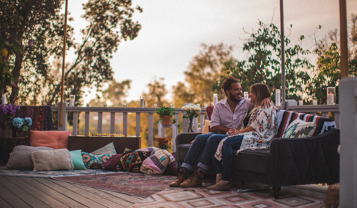 two people sitting outside on a deck